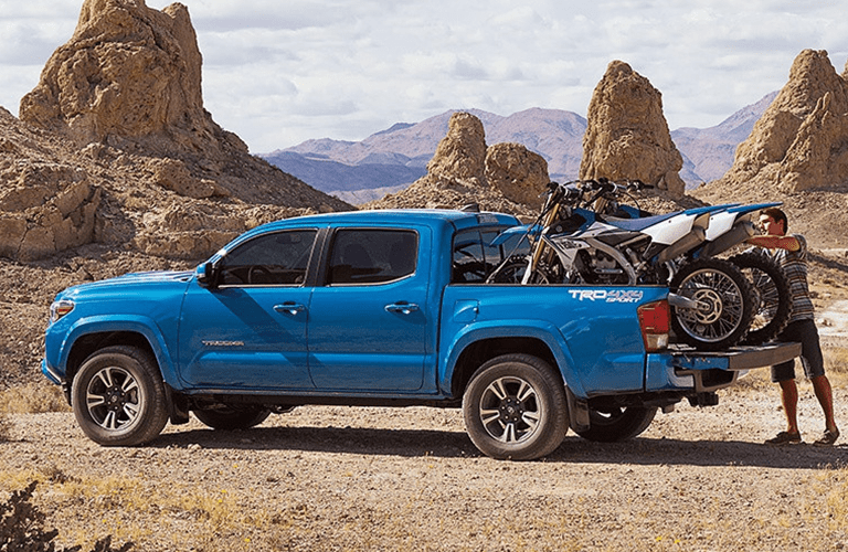 Toyota Tacoma Exterior View in Blue with Dirt Bikes in Truck Bed