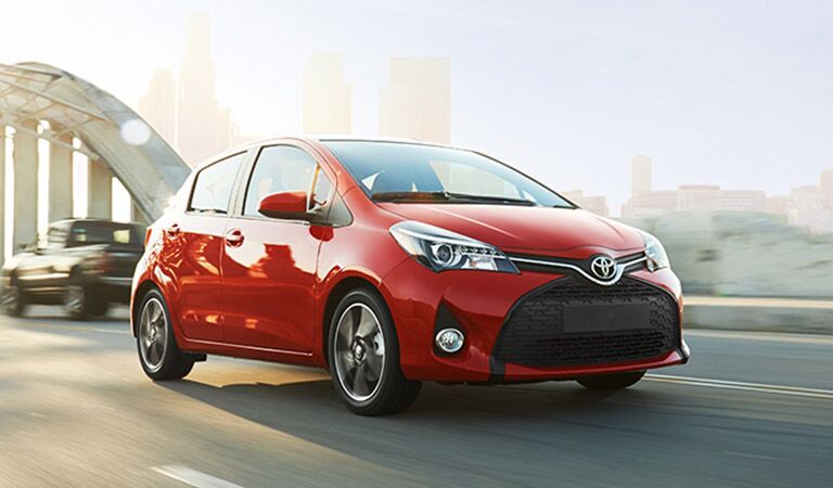 Red Toyota Yaris Driving Down Highway