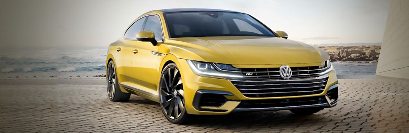 Yellow 2019 VW Arteon parked on brick pavement