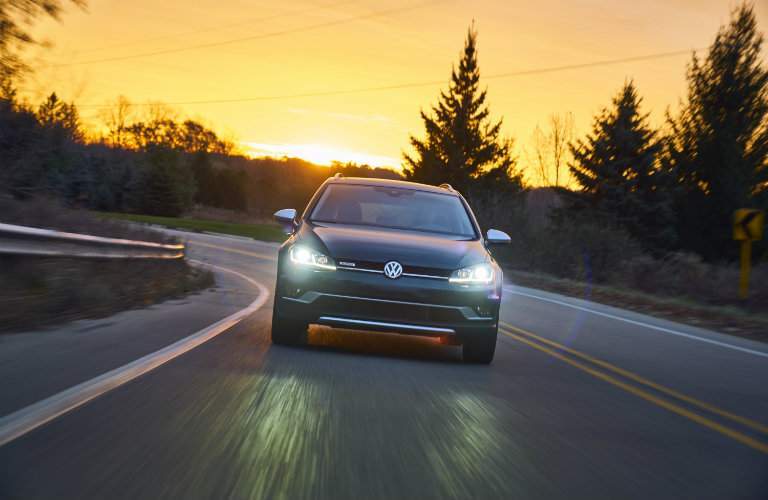 2018 Volkswagen Golf Alltrack driving at sunset