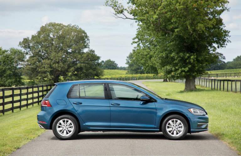 2018 Volkswagen Golf side shot parking on country road with trees and fences