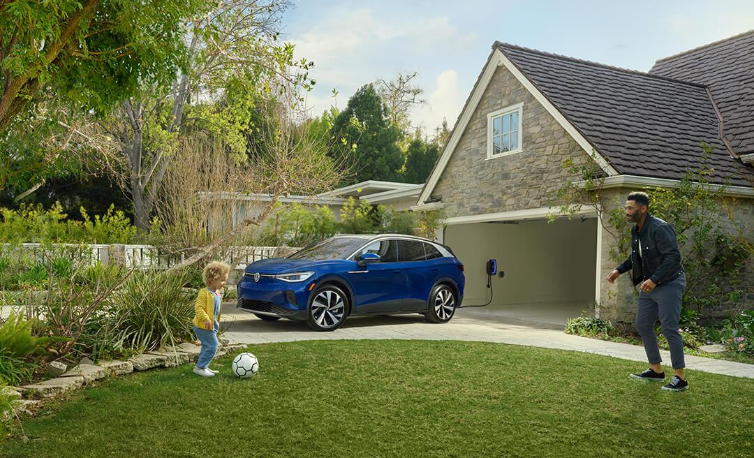 An ID.4 in Dusk Blue Metallic is parked in a residential driveway.