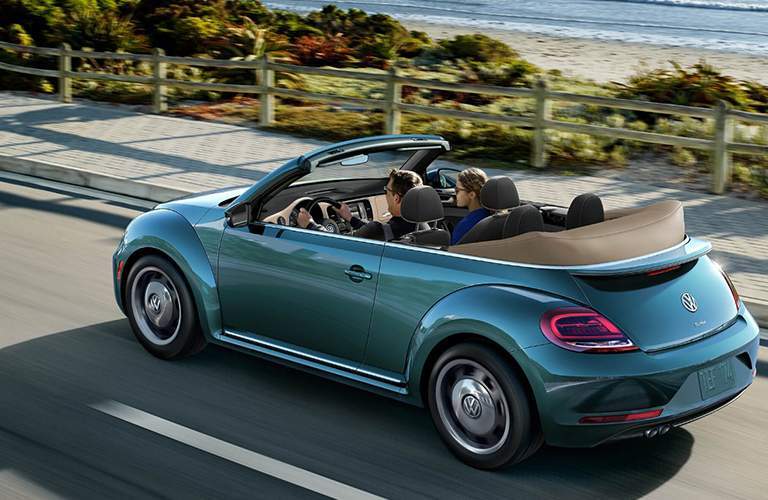 2018 Volkswagen Beetle Convertible driving down road by beach