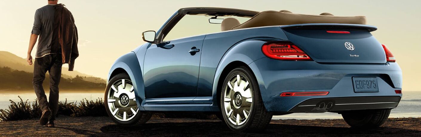 Blue 2018 VW Beetle Convertible parked by water