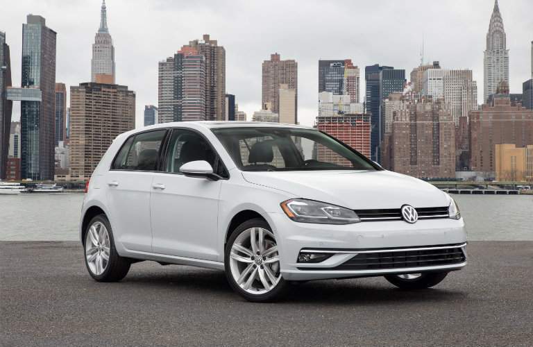 2018 Volkswagen Golf parked by sea and city background