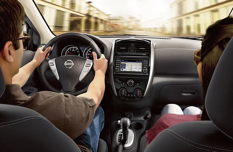 View of 2017 Nissan Versa Sedan front Seats in Black with Two People in Driver and Passenger Seat
