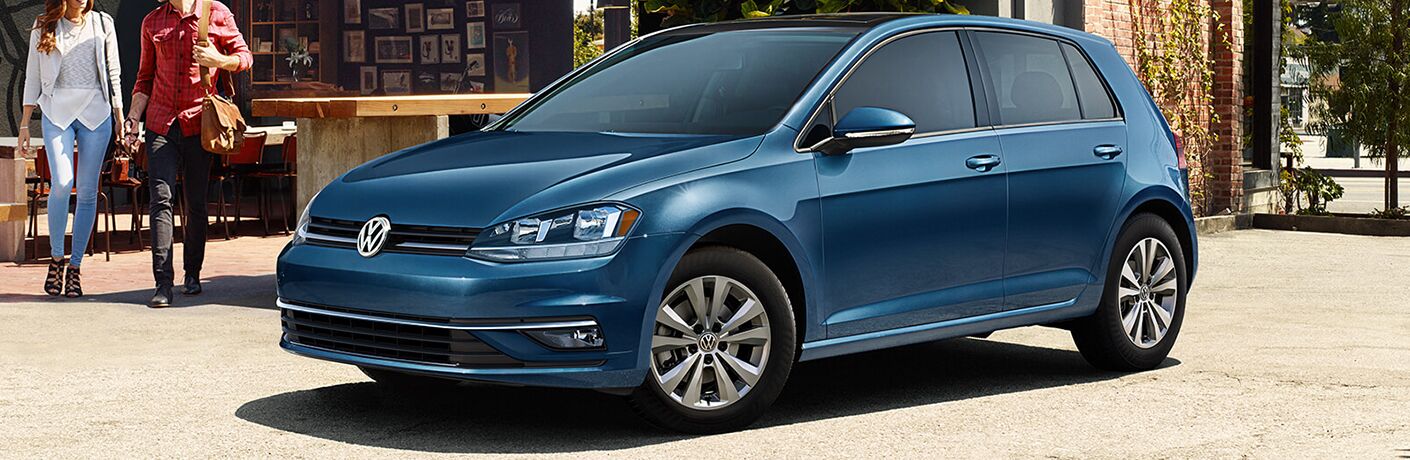 A couple walking towards a 2019 Volkswagen Golf