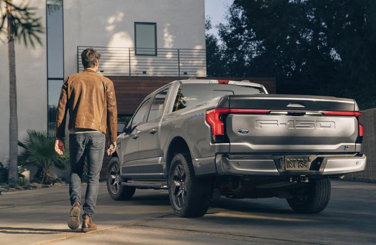 Silver 2023 Ford F-150 Lightning Rear Exterior in a Driveway