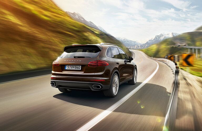 Used Porsche Cayenne rear view on road