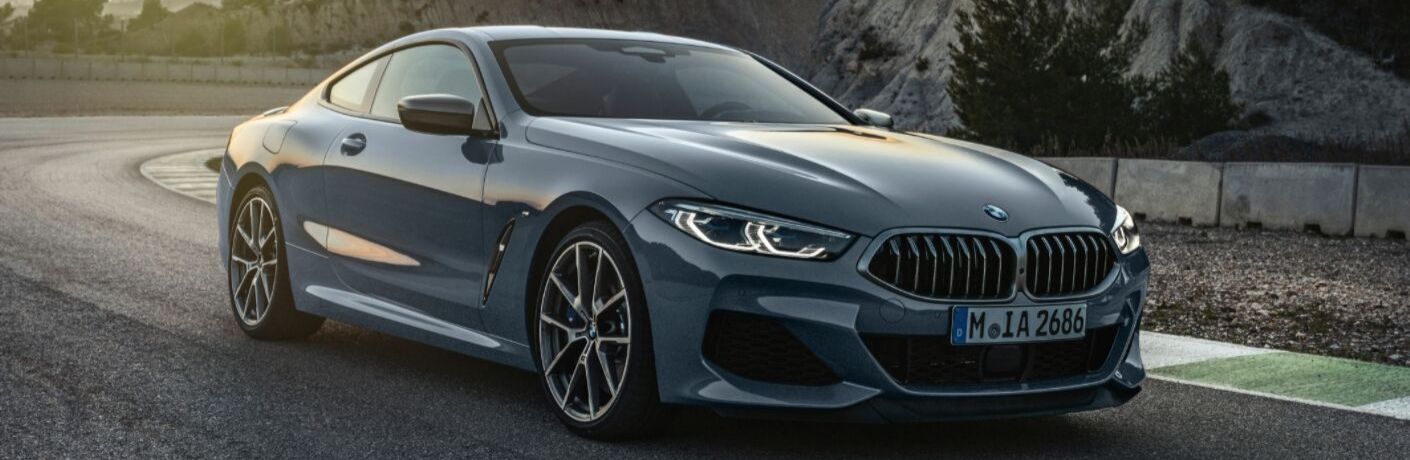 Blue 2019 BMW 8 Series on Mountain Road at Sunset