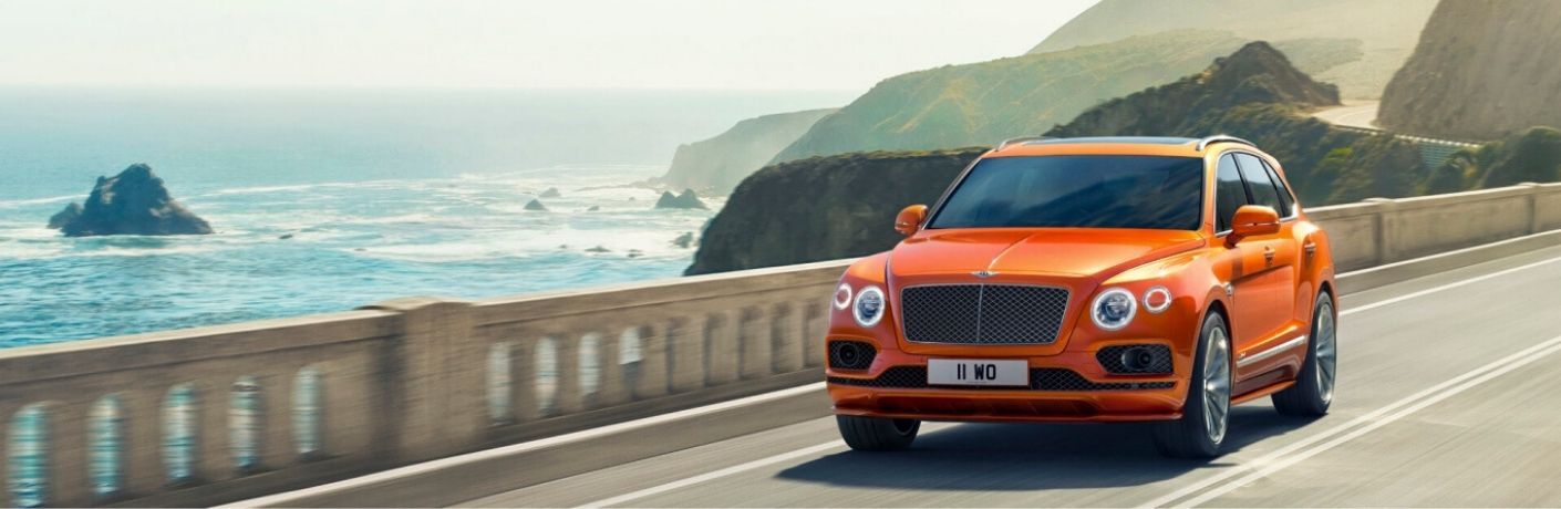 Orange 2020 Bentley Bentayga on a Bridge