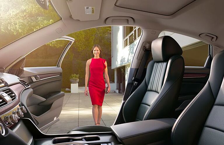 woman walking toward passenger side of 2020 Honda Accord viewed through front seat