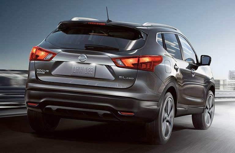 gray 2017 Nissan Rogue Sport driving along bridge