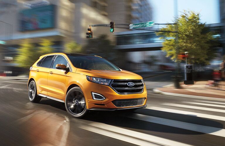 Golden 2016 Ford Edge on the road