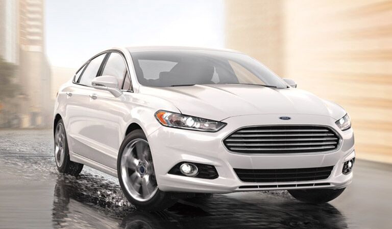 White Ford Fusion driving through water
