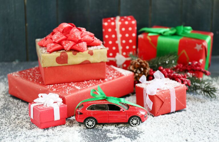 Gifts surrounding a small toy car
