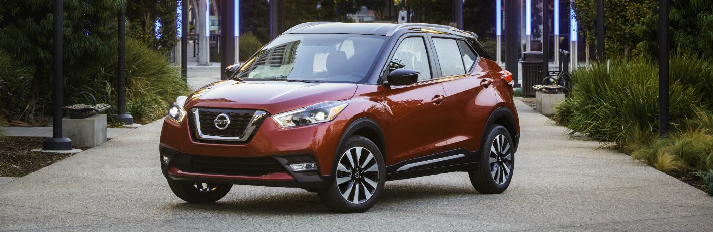 Red 2018 Nissan Kicks parked on a walkway
