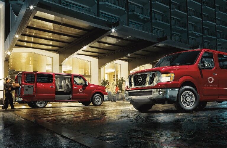 two 2021 Nissan NV models parked outside hotel