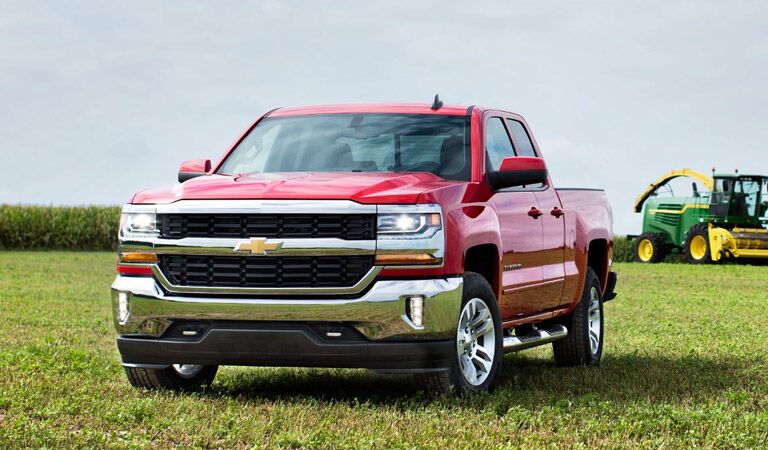 Chevy Silverado 1500 light-duty full-size truck in red on a farm
