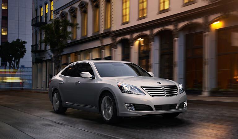 grey 2016 Hyundai Equus driving through the old city at night
