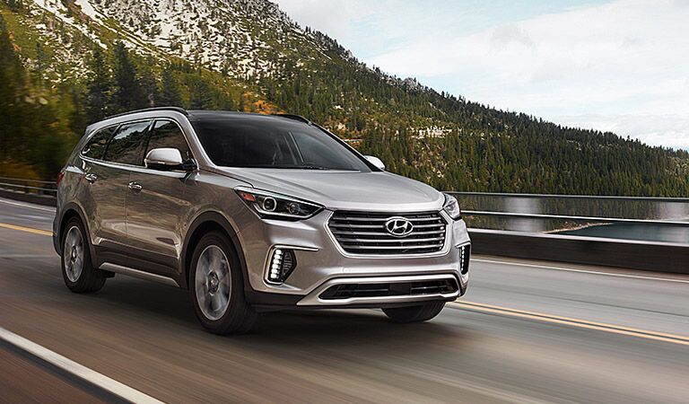 grey or silver 2017 Hyundai Santa Fe driving near a bay