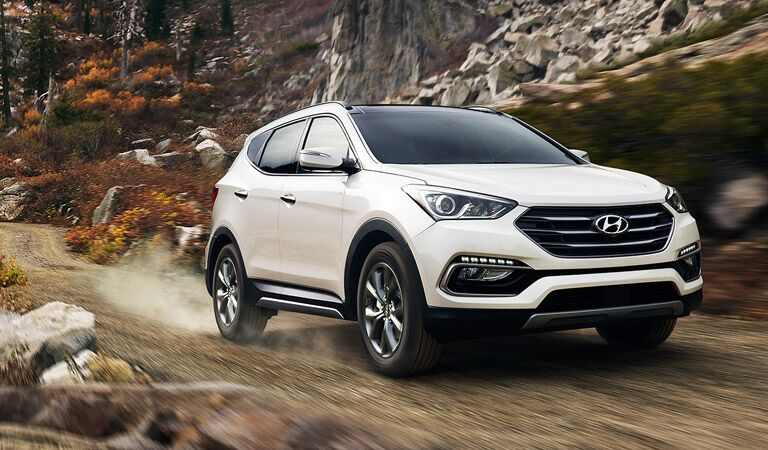 white 2017 Santa Fe Sport tackling rough mountain paths