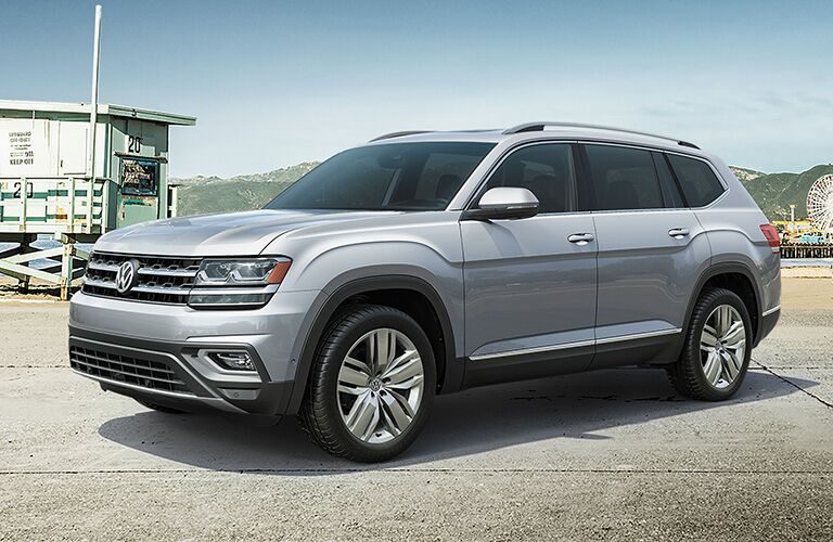 silver Volkswagen Atlas parked by beach, carnival area