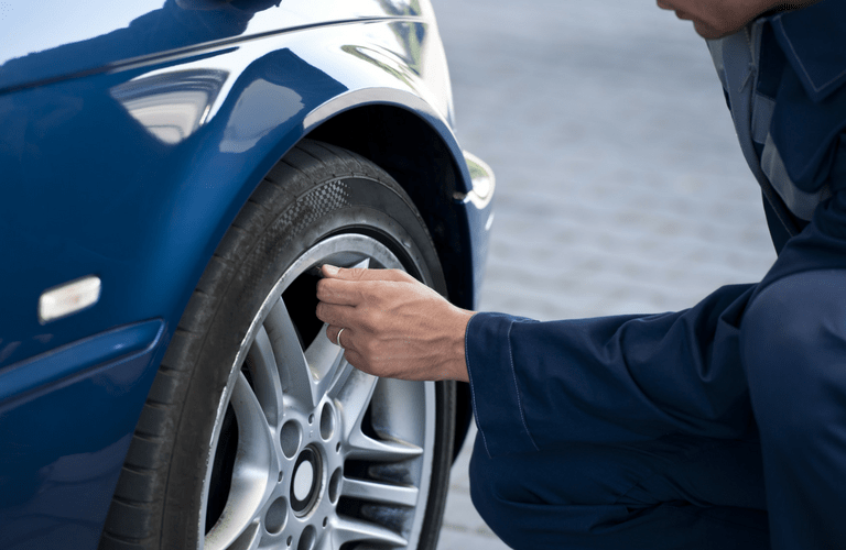 Mechanic checking tire pressure
