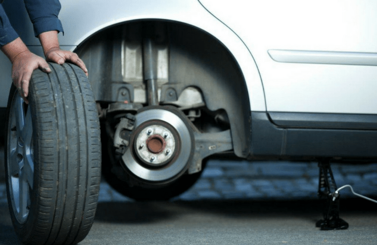 Tire being removed from car