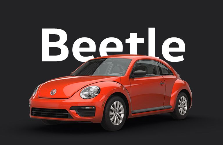 Orange Volkswagen Beetle sits against a black background and gigantic white text that reads, "Beetle."