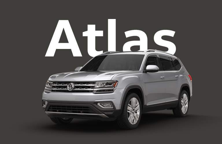Silver Volkswagen Atlas sits in front of a black background under large white text that reads, "Atlas."