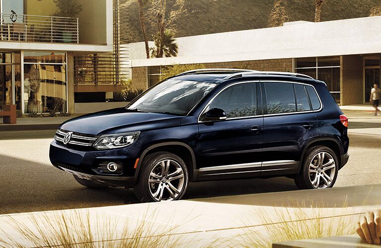 Deep blue Volkswagen Tiguan parked in a modern neighborhood.