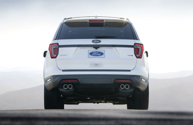 rear view of a white 2018 Ford Explorer parked in fog