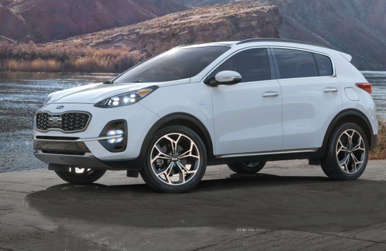 white 2019 kia sportage on the beach
