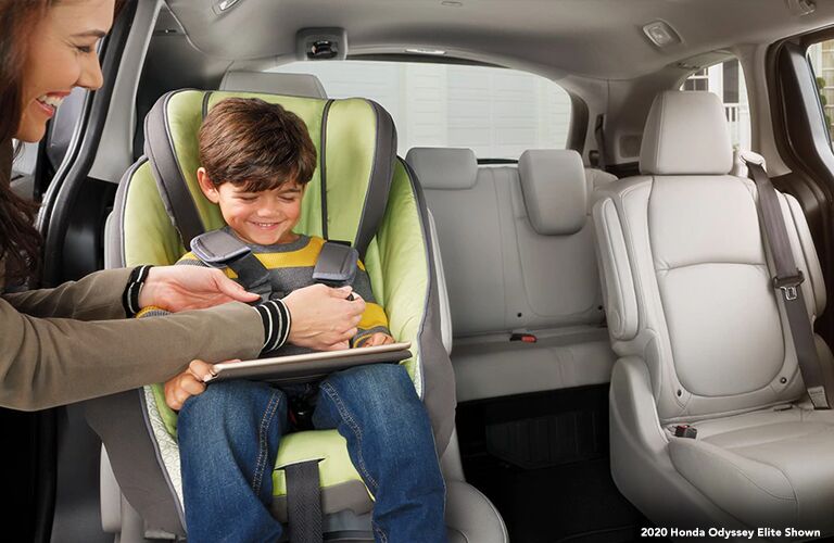 Mother buckling up her kid in a carseat inside the 2020 Honda Odyssey