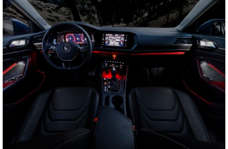 2019 Volkswagen Jetta interior front seat dashboard and steering wheel with ambient red lighting