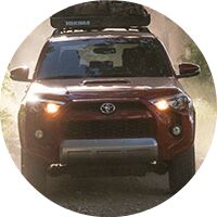 red 2017 Toyota 4Runner with gear on top exterior front