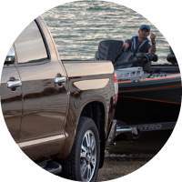 closeup on boat and man being pulled from water by 2018 Toyota Tundra