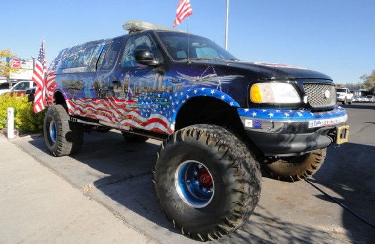 2001 Ford F-150 XL with American flag design and oversized tires