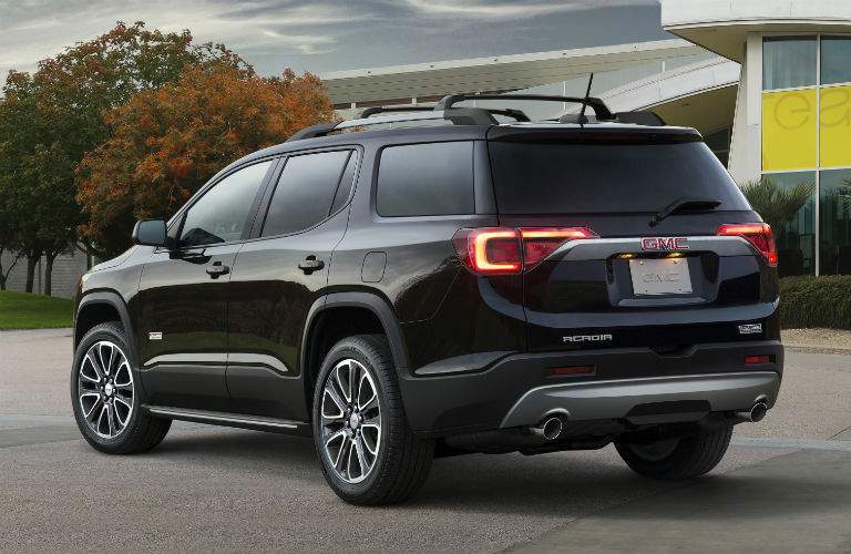 Rear-facing profile shot of black GMC Acadia crossover