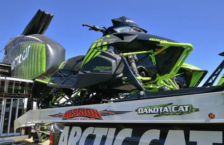 Arctic Cat snowmobile parked in trailer bed
