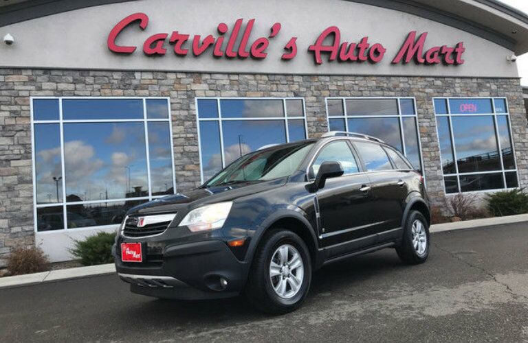 Black Saturn VUE SUV parked in front of Carville's Auto Mart exterior
