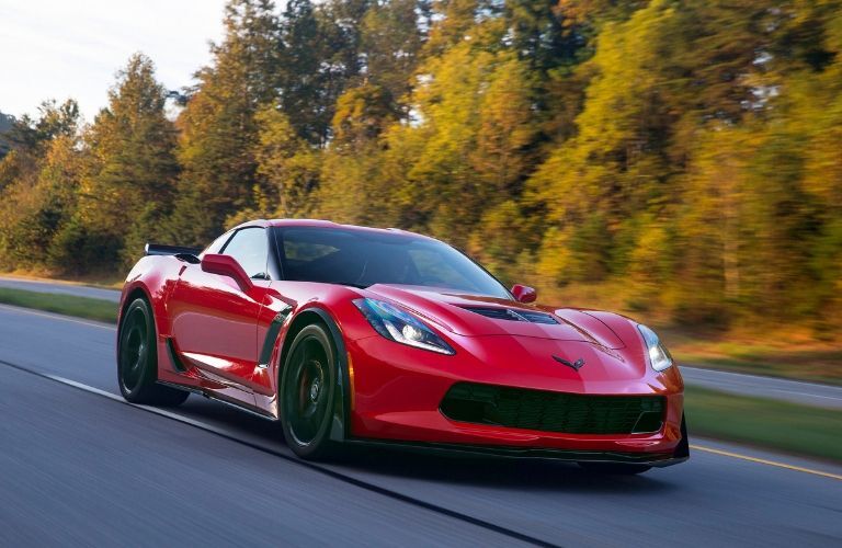 red_2016_Chevy_Corvette_Z06_speeding_past_trees