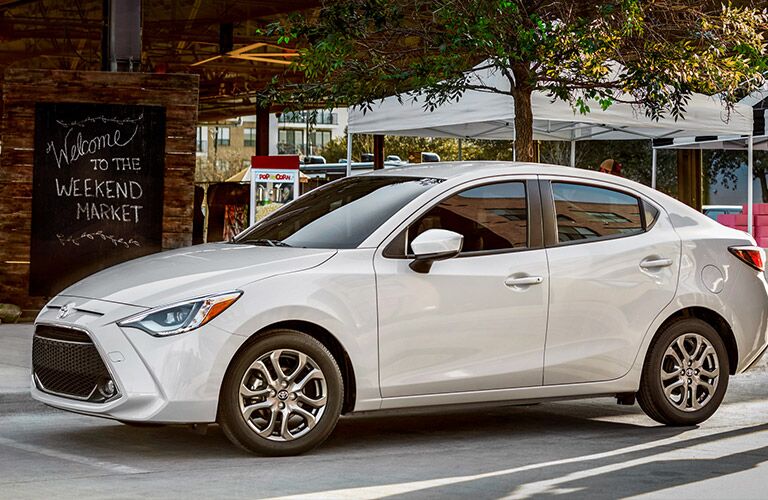 White 2019 Toyota Yaris driving down the street