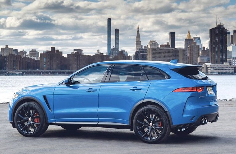 Blue 2019 Jaguar F-PACE SVR Side Exterior with City Skyline in the Background