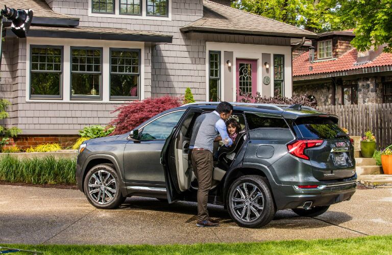 2018 GMC Terrain Denali parked in driveway with man opening back door