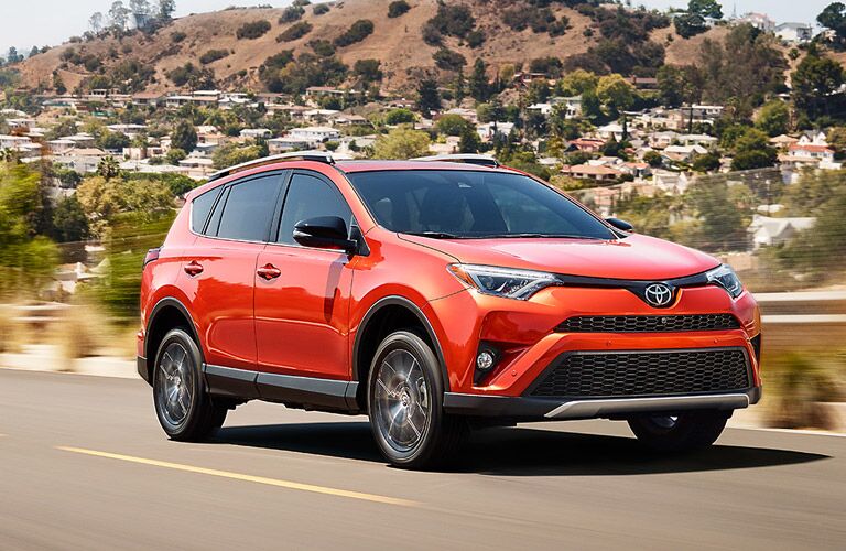 Orange 2017 Toyota RAV4 on the Highway