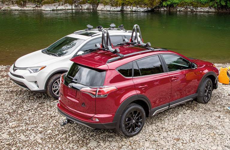 Overhead View of Red and White 2018 Toyota RAV4 Models Next to a River