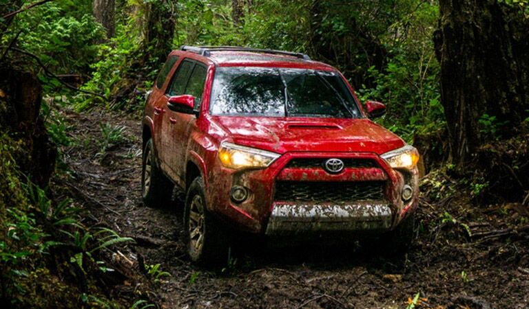 Red 2016 Toyota 4Runner on Muddy Trail