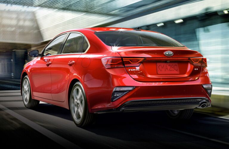 Driver's side rear angle view of red 2020 Kia Forte
